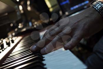 Piano Keyboards In Music Studio And A Hand Of A Musician 