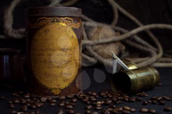  Vintage Rusted Coffee Tin Canister and Grinder With Coffee Beans On a Rustic Background