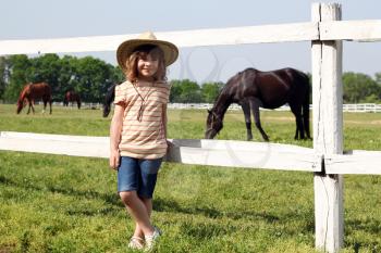 little girl on horse farm