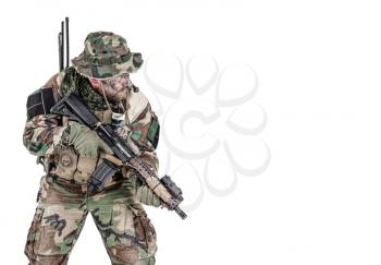 Special forces United States in Camouflage Uniforms studio shot. Holding weapons, wearing jungle hat, Shemagh scarf, painted face, his outfit clothes designed for jungle warfare. Studio shot isolated