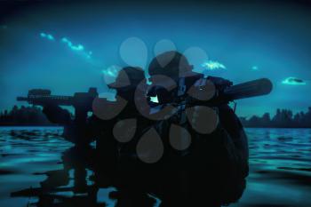 Silhouette of special forces with rifle in action during river raid in the jungle waist deep in the water. Under cover of darkness