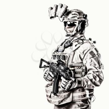 Army elite soldier with hidden behind mask and glasses face, in full tactical ammunition, equipped night vision device, radio headset, armed short barrel service rifle studio shoot on white background