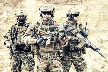 Group portrait of US army elite members, private military company servicemen, anti terrorist squad fighters standing together with guns. Brothers in arms, war conflict combatants, soldiers of fortune