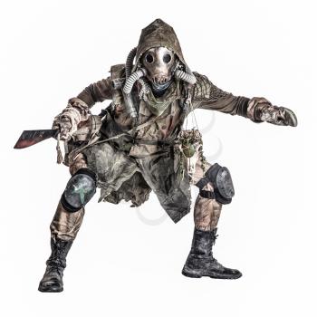 Dangerous, mysterious post apocalypse creature, global ecological disaster survivor in tatter, gas mask, wearing mystical amulet, crouching with bloody machete in hands isolated on white studio shoot