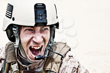 Scary face of US marine in the marpat uniform showing teeth
