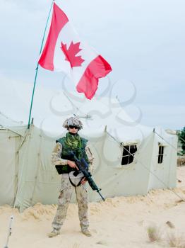 canadian soldier in desert uniform near the army tent
