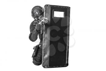 Studio shot of swat police special forces aiming criminals with rifle hiding behind ballistic shield. Isolated on white