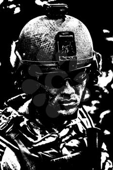 Grimy dirty and tired face of US Army Ranger, young boy wearing eyewear and combat helmet. Closeup