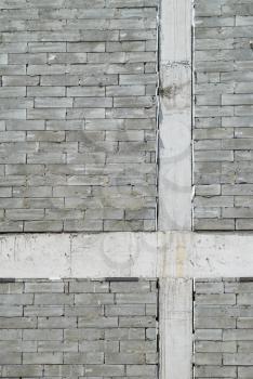 A wall of textured gray construction bricks.