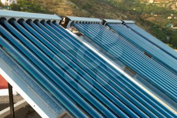 Vacuum solar water heating system on the house roof.