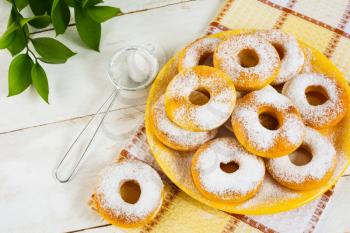 Sweet donuts powdered by caster sugar. Doughnuts. Sweet pastry. Sweet dessert. Donuts. 