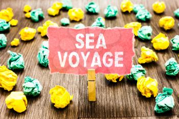 Word writing text Sea Voyage. Business concept for riding on boat through oceans usually for coast countries Clothespin holding pink note paper crumpled papers several tries mistakes