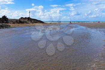 BUDE, CORNWALL/UK - AUGUST 12 : Walking along the Beach at Bude in Cornwall on August 12, 2013. Unidentified people