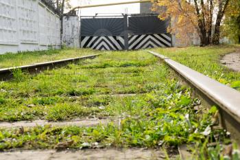 Abandoned old railroad with green grass, summer time.