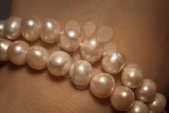 Beaded bracelet made of fresh water pearls, filtered background.
