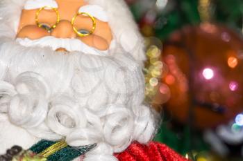 Christmas santa toy playing the accordion, holiday background.