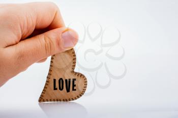 LOVE wording heart shaped wooden object in the hand