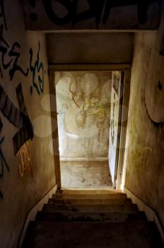 Staircase and exit door of an abandoned house.