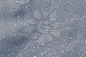 Raindrops on transparent plastic background texture. Selective focus.