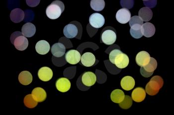 Blurry light circles colorful dots pattern at night. Abstract background.