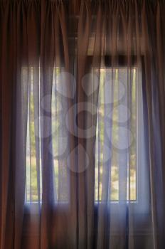 Closed window curtain abstract background. Bright summer daylight and shade.