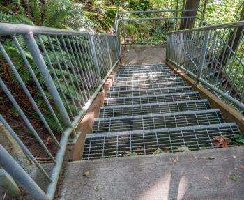 Metal stairs criss-cross leading down to the Puget Sound at Eagle Landing Park in Burien, Washington.