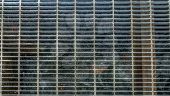 HDR image of a metal grate over water.