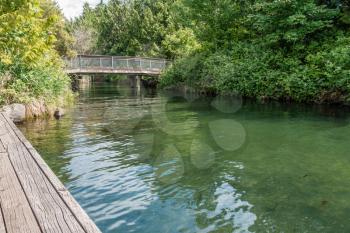 A view of a wooden walking bridge at Getn Coulon Park in Renton, Washington.