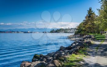 Majestic Mount Rainier towers over the Ruston shoreline near Tacoma, Washington.