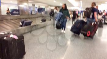 Airport baggage carousel with blurred people at LAX