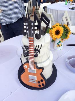 Guitar cake edible musical instrument for birthday with notes black and white with daisy