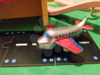 Plane at airport runway in toy city play town in miniature size