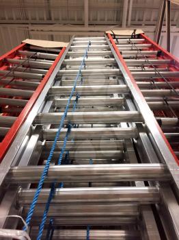 Metal fiberglass ladders at home improvement warehouse store climbing high concept