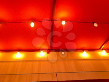 Red canopy awning with yellow light bulbs restaurant atmosphere background