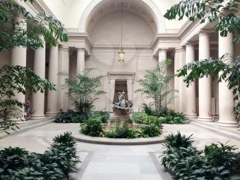 Beautful inside foyer with columns and green plants statues