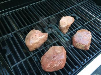 filet mignon on bbq barbecue grill background cooking