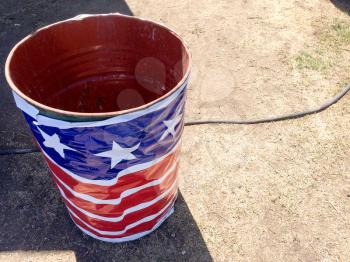 Trash can wrapped in american flag banner concept for recycle problem