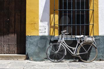 Vintage bicycle parked in front of the colorful wall