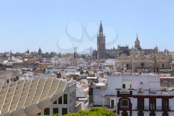 View of Giralda from Metropol Parasol in Seville on a bright day with blue sky