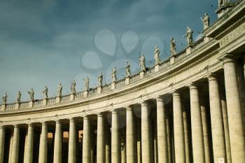 Column and statues at St-Peter's square at Vatican city in Italy