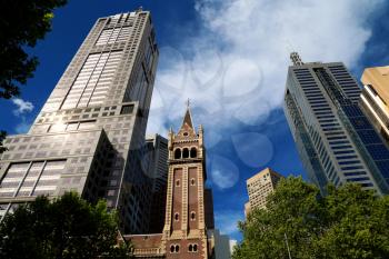 Bell tower of St-Michael uniting church with business buildings in background in Melbourne, Australia