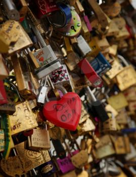 Red love padlocks heart shaped on the pont des arts, bridge in Paris