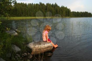 Royalty Free Photo of a Little Girl at a Lake