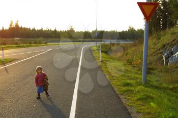 Royalty Free Photo of a Little Girl on a Road