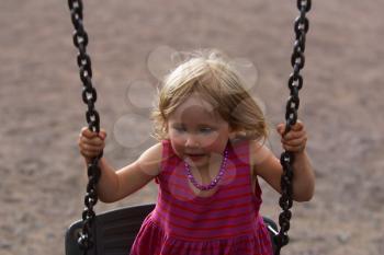 Royalty Free Photo of a Little Girl Swinging