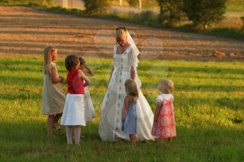 Royalty Free Photo of a Bride and Kids in a Field