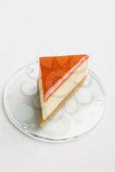 A triangular dessert on a clear dessert plate.