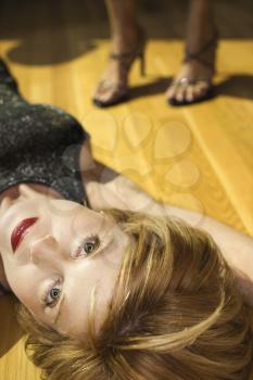 Royalty Free Photo of a Woman Lying on a Wooden Floor