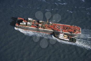 Royalty Free Photo of an Aerial view of tugboat pushing tanker