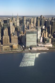 Royalty Free Photo of an Aerial view of Midtown Manhattan, New York with United Nations Headquarters building reflecting in East River